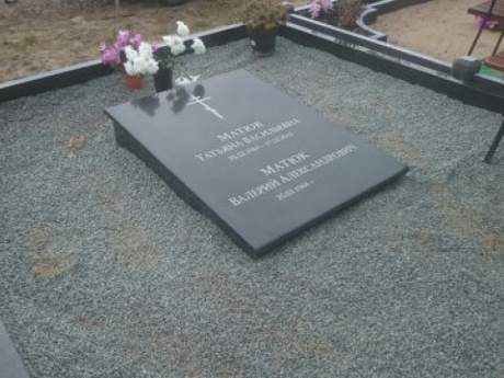 Granite closed grave slab with a sloped surface 